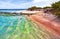 Maldivian shoreline with transparent water hits the coral reef