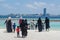 Maldivian women and children walking towards ocean at the tropical beach