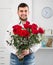 Male 25-30 years old is presenting flowers and gift