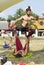 Male actors train next to a circus tent.