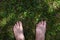 Male adult funny feet on green grass