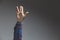 male adult hand showing prosperity wish gesture in studio shot isolated on grey background - finger split gesture