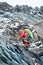 Male alpinist climbing rocky mountain.