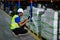 Male american african factory company employee scanning box checking number of products on goods shelves with tablet in warehouse