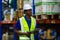 Male american african factory company employee scanning box checking number of products on goods shelves with tablet in warehouse