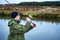 Male angler catches on a spinning fish in cold water in the offseason.