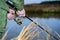 Male angler catches on a spinning fish in cold water in the offseason.