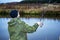 Male angler catches on a spinning fish in cold water in the offseason.