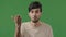 Male angry unsatisfied portrait in green studio arab man indian irritated young guy feel displeasure upset make lost