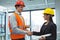 Male architect shaking hands with businesswoman