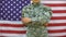 Male army doctor with stethoscope on american flag background, first aid, health