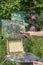 Male artist paint on plein air flowers pink peonies painting on nature