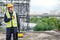 Male Asian mechanic carrying work tool at site