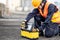 Male Asian mechanic preparing work tool at site