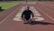Male Athelete in meditation breathing excersise at Stanford University sport track . Stanford California USA january