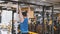 Male athlete - bodybuilder doing pull-up bar abdominal exercise in gym