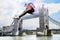 Male Athlete hurdling Tower Bridge