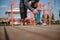 Male athlete legs on a sports field, sportsman taking a bottle with water , rehydrating his body during workout outdoor. Close-up