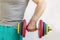 Male athlete lifting a heavy dumbbell with one hand. Home Workouts During the Coronavirus Pandemic: A Healthy Lifestyle Concept