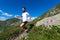 Male athlete practicing mountain running on a trail marked by th