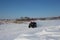 Male athlete rides a quad bike in the snow in winter in Siberia entertainment