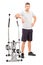 Male athlete standing next to a cross trainer machine