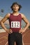 Male Athlete Standing On Racetrack