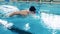 Male athlete swimming butterfly. Close up