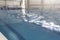 A male athlete swims in a swimming pool sports complex in blue water