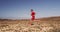 Male athlete training at running trail in desert landscape in Slow motion.