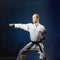 Male athlete trains formal karate exercise