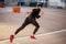 Male athlete wearing black sportwear running at track, side view