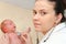 Male Baby gets a lung examination by a nurse with stethoscope