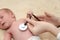 Male Baby gets a lung examination by a nurse with stethoscope