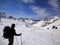 Male backcountry skier looks at mountain landscape and his goal for the day`s backcountry ski tour
