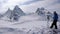 Male backcountry skier on top of a remote alpine summit admiring the fantastic mountain landscape view in front of him