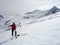 Male backcountry skier using a map on a high alpine glacier in the Austrian Alps and pointing to the right direction