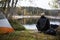 Male Backpacker Enjoying The View Of Lake At Campsite