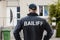 Male Bailiff Standing At House Entrance