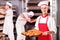 Male baker holding croissants in bakery