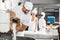 Male Baker Pouring Flour In Kneading Machine