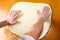 Male baker spreading dough for making pizza