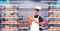 male baker in uniform holding bread bakery products baking manufacture concept portrait