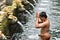 Male balinese having a ritual bath at Holy Spring Water