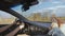 Male bare feet on the dashboard of a moving car. traffic on the motorway