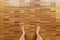 Male bare feet stand on a wooden floor
