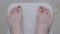 Male bare feet stepping on digital floor scales - man weighing himself: top view