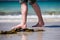 Male bare feet in a warm sand