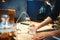 Male barista pours filtered water into the glass