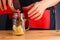 Male bartender make citrus cocktail. non alcoholic summer drinks with citrus on wooden table